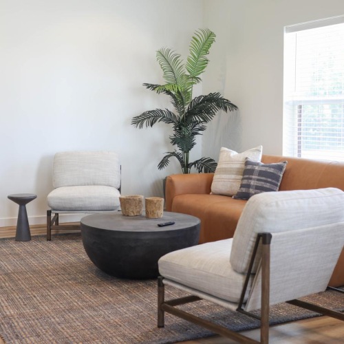 a spacious living room with two windows and wood-style flooring at 98 Penn Place in East Pennsboro Township, PA