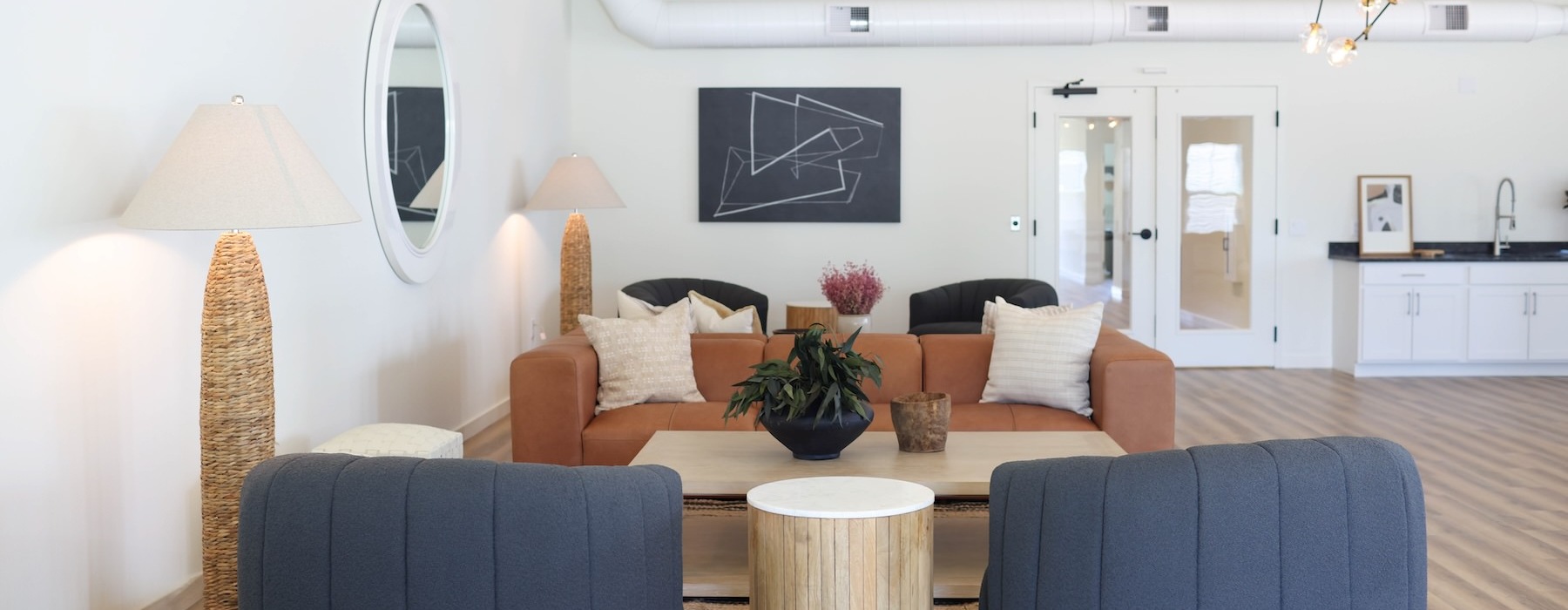 a clubroom with a couch, table and chairs