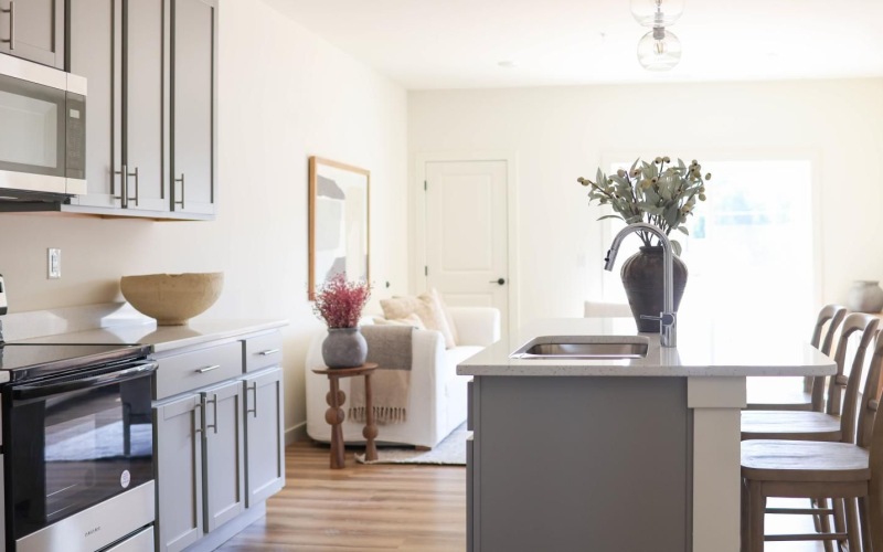 a kitchen with an island and natural lighting at 98 Penn Place in East Pennsboro Township, PA